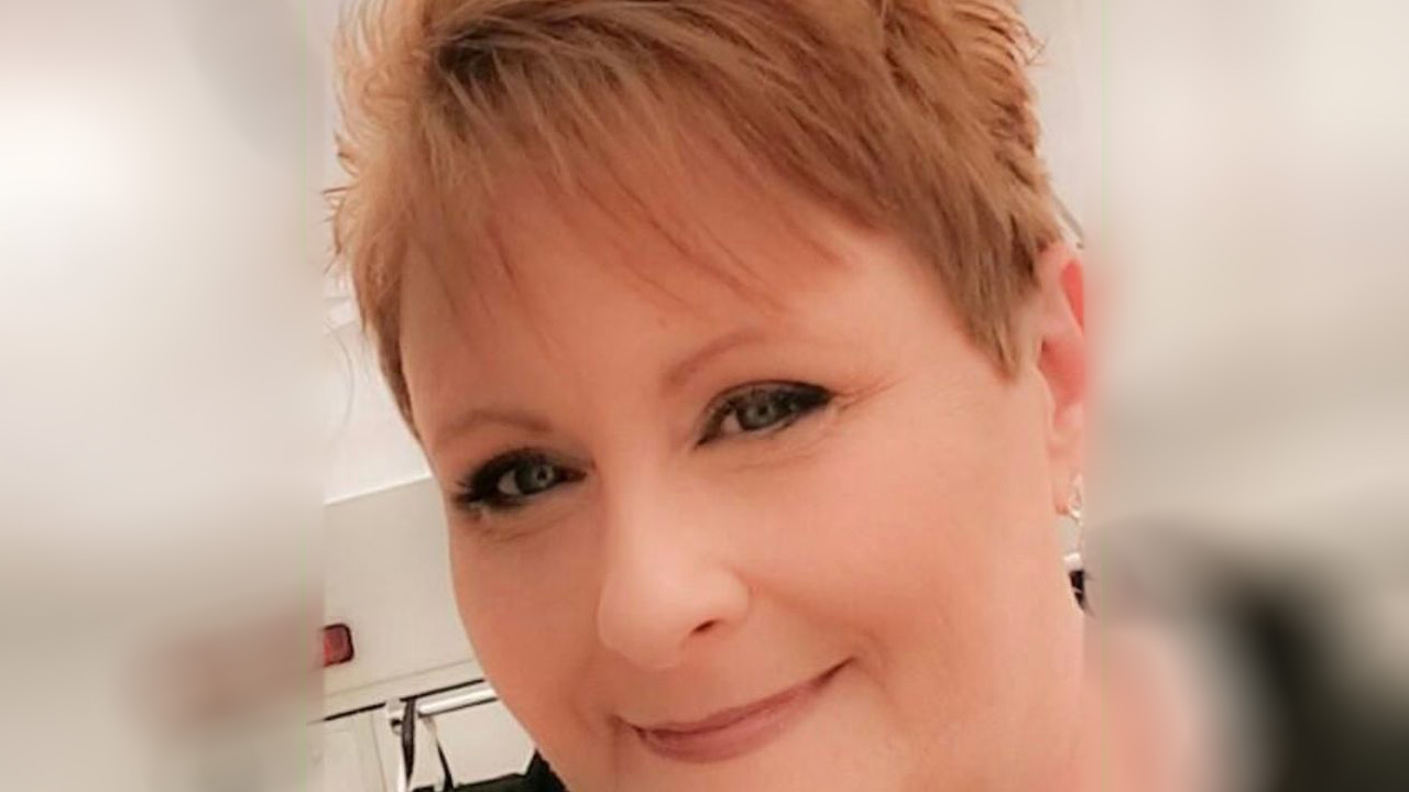 A woman with short hair is smiling for the camera.