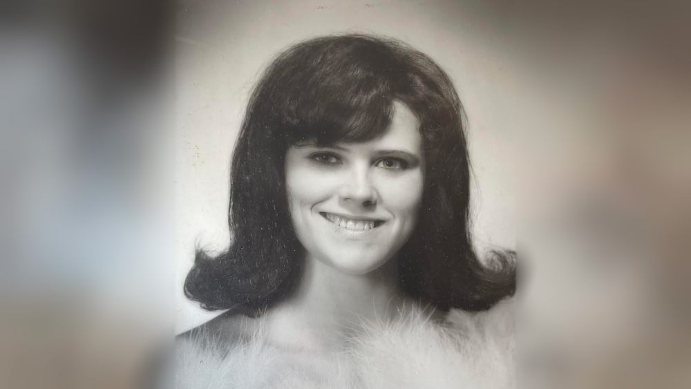 A black and white photo of a woman with long hair.