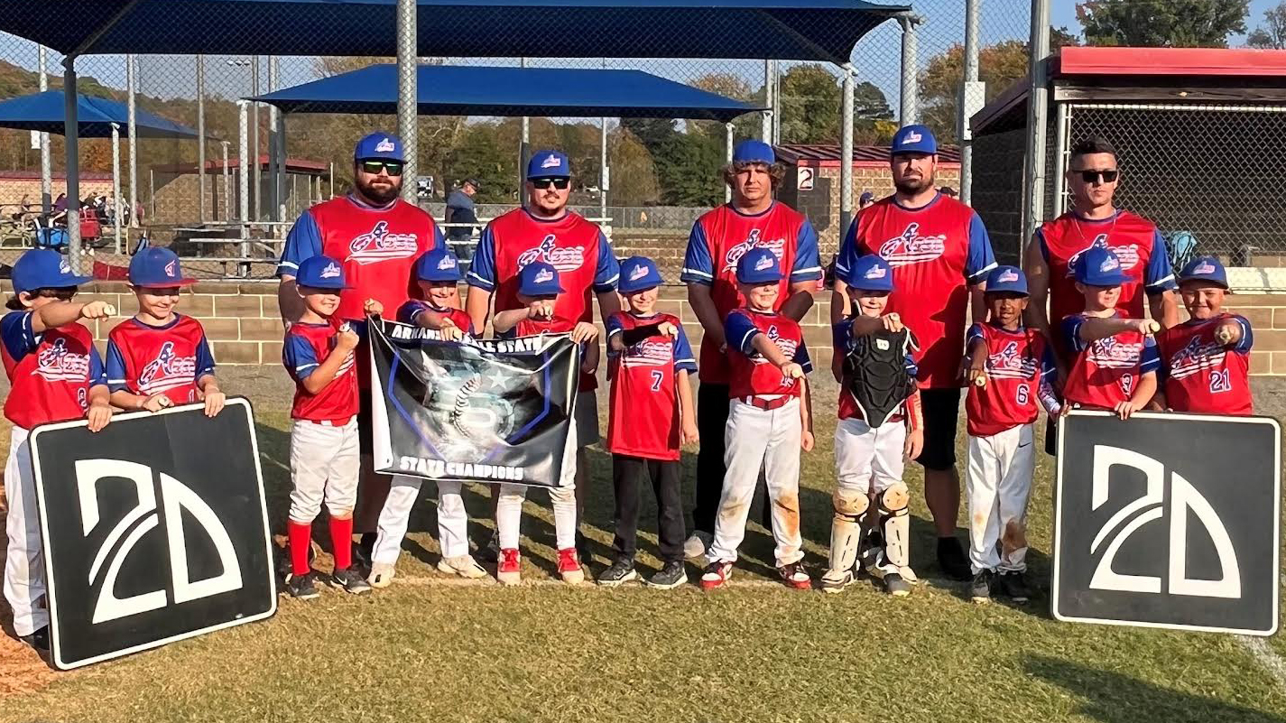 A group of young baseball players standing on top of a field.
