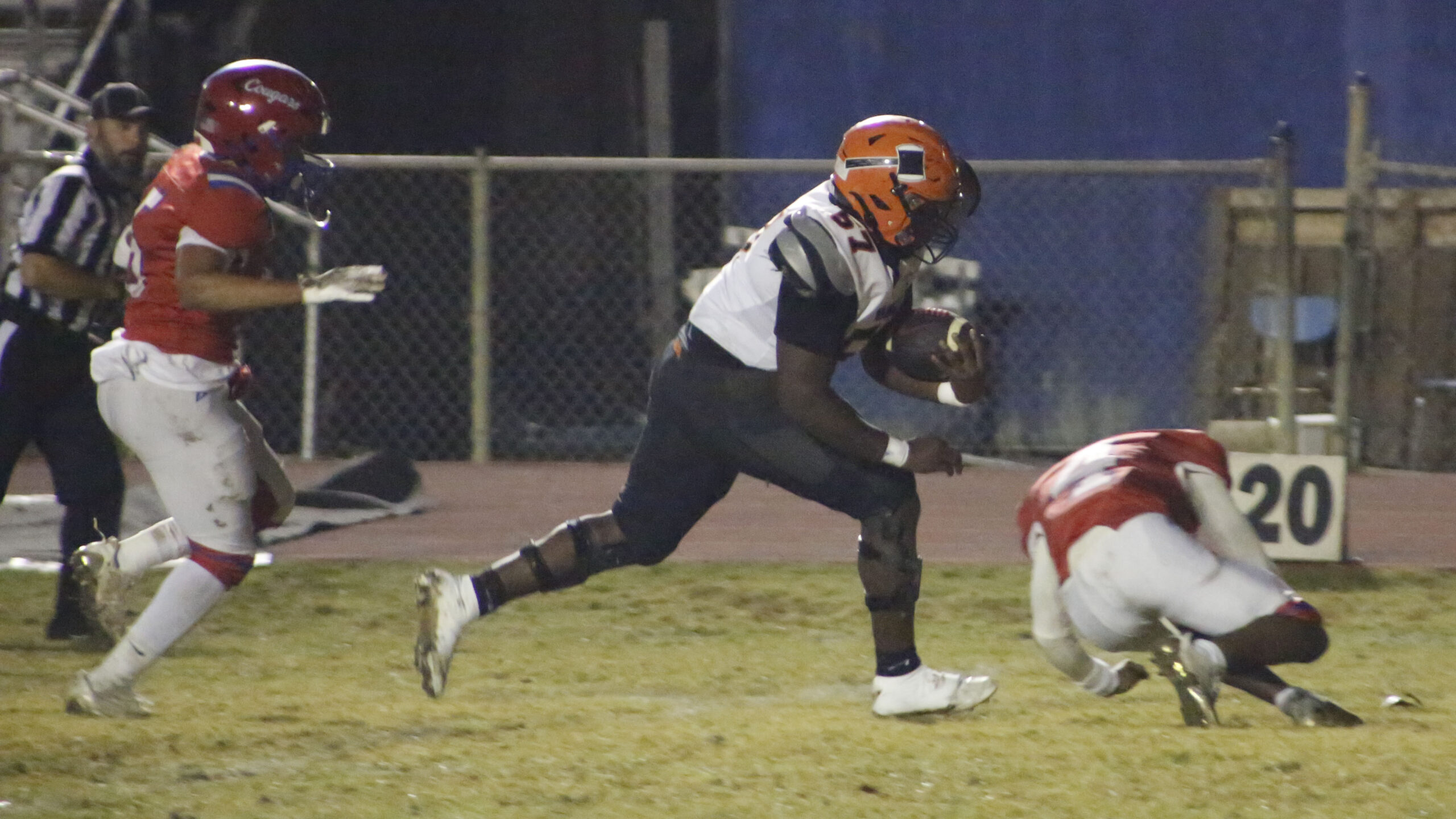 A football player running after the ball