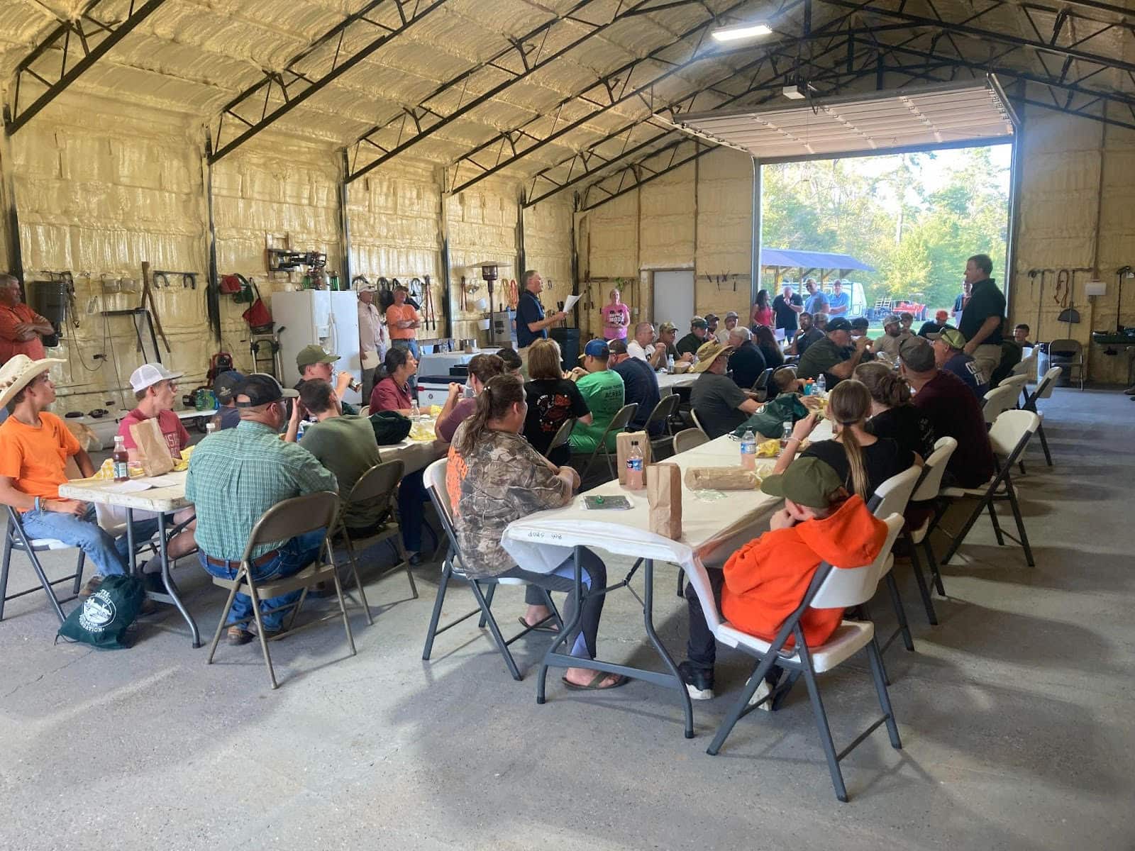A group of people sitting at tables in a building.