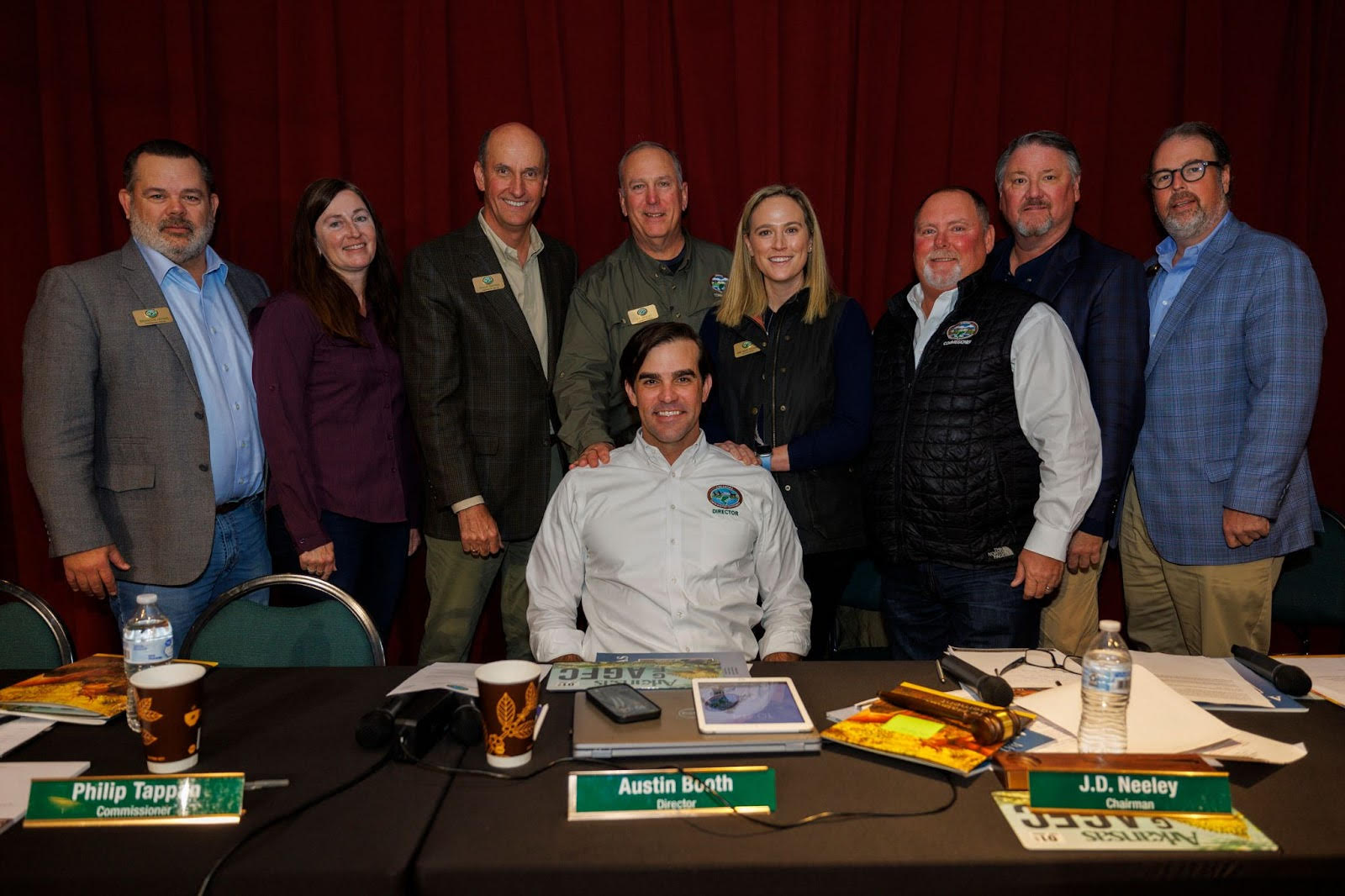 A group of people standing around a table.