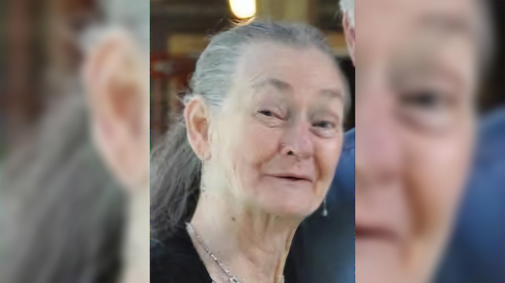 A woman with long hair and a necklace.