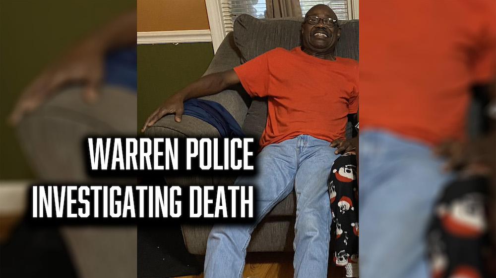 A man sitting on the couch in front of a tv.