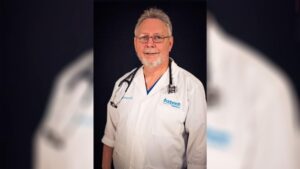 A man in white lab coat with stethoscope.