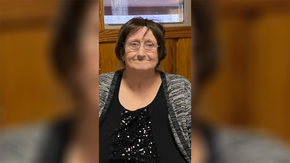 A woman with glasses and a black shirt