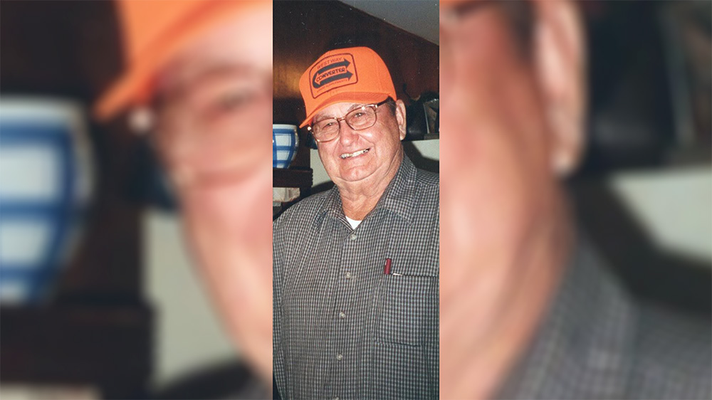 A man wearing an orange hat and glasses.