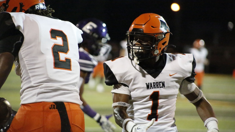 A football player in an orange and white uniform.