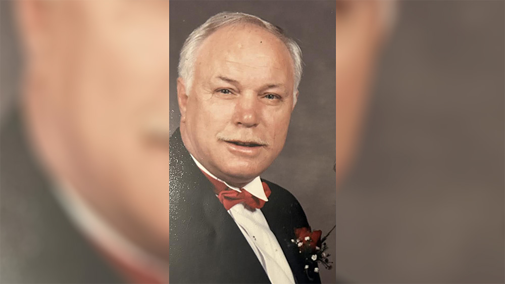 A man in a suit and bow tie.