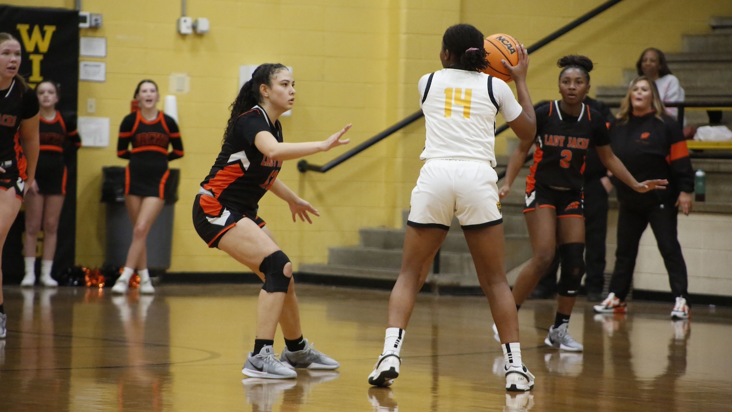 A group of girls playing basketball on the court.