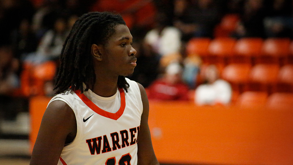 A young man in white and red basketball uniform.