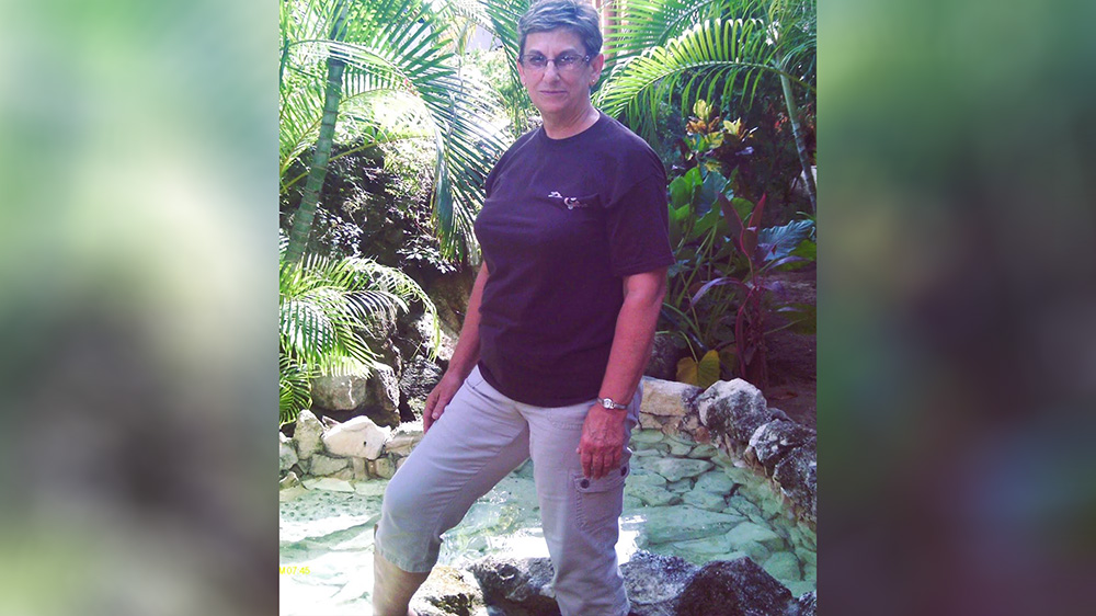 A man standing in the middle of some rocks.