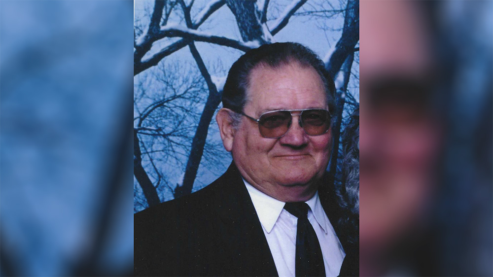 A man in suit and tie wearing sunglasses.