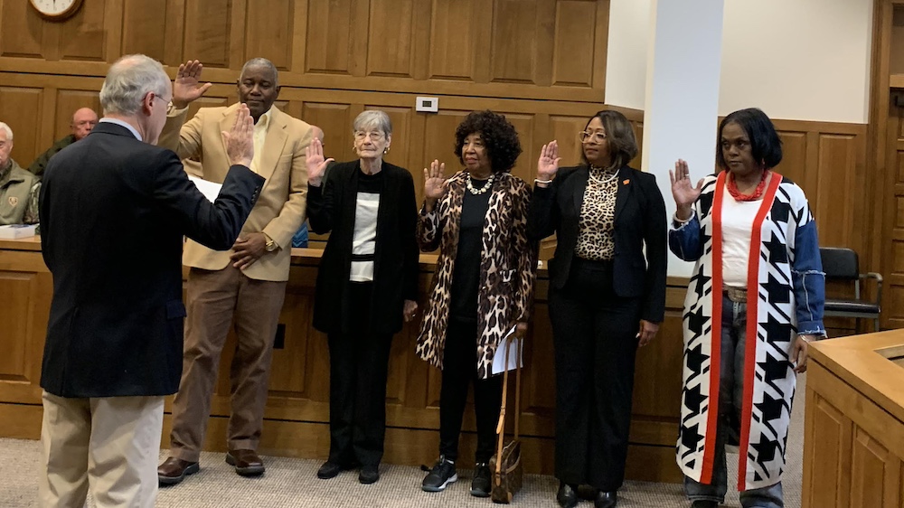 A group of people are taking their oath.