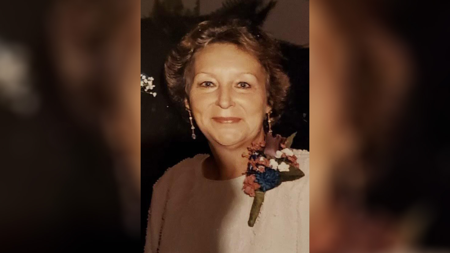 A woman with a bouquet of flowers in her hand.