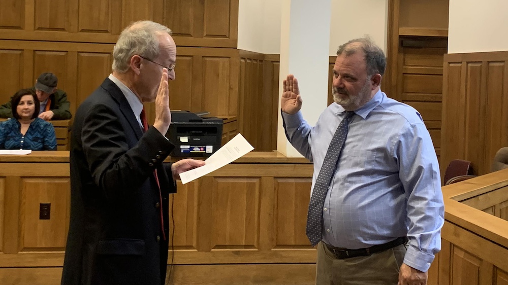 A man is being sworn in by another person.