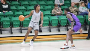 A man holding a basketball in front of another person.
