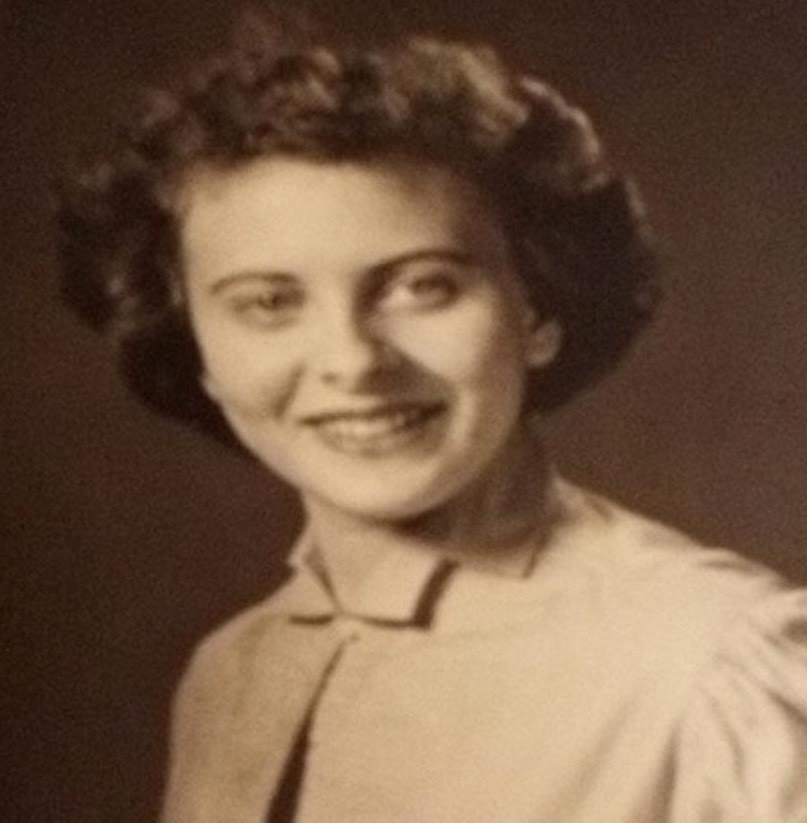 A woman in a brown shirt and black jacket