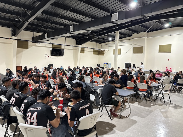 A large group of people sitting at tables.