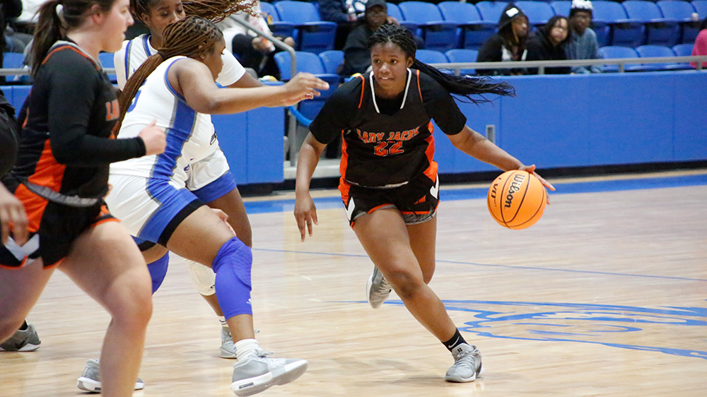 A group of women playing basketball on a court.