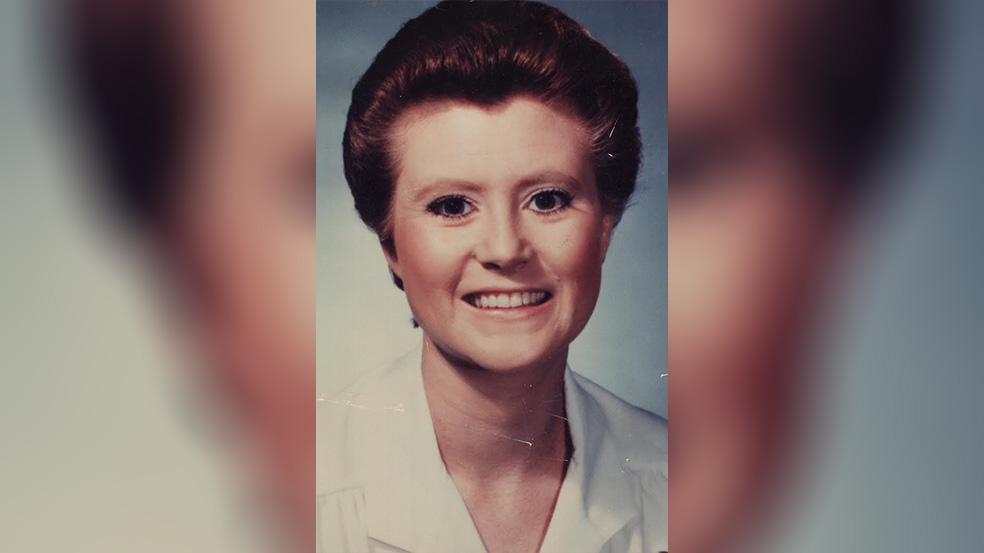 A woman with short hair is smiling for the camera.