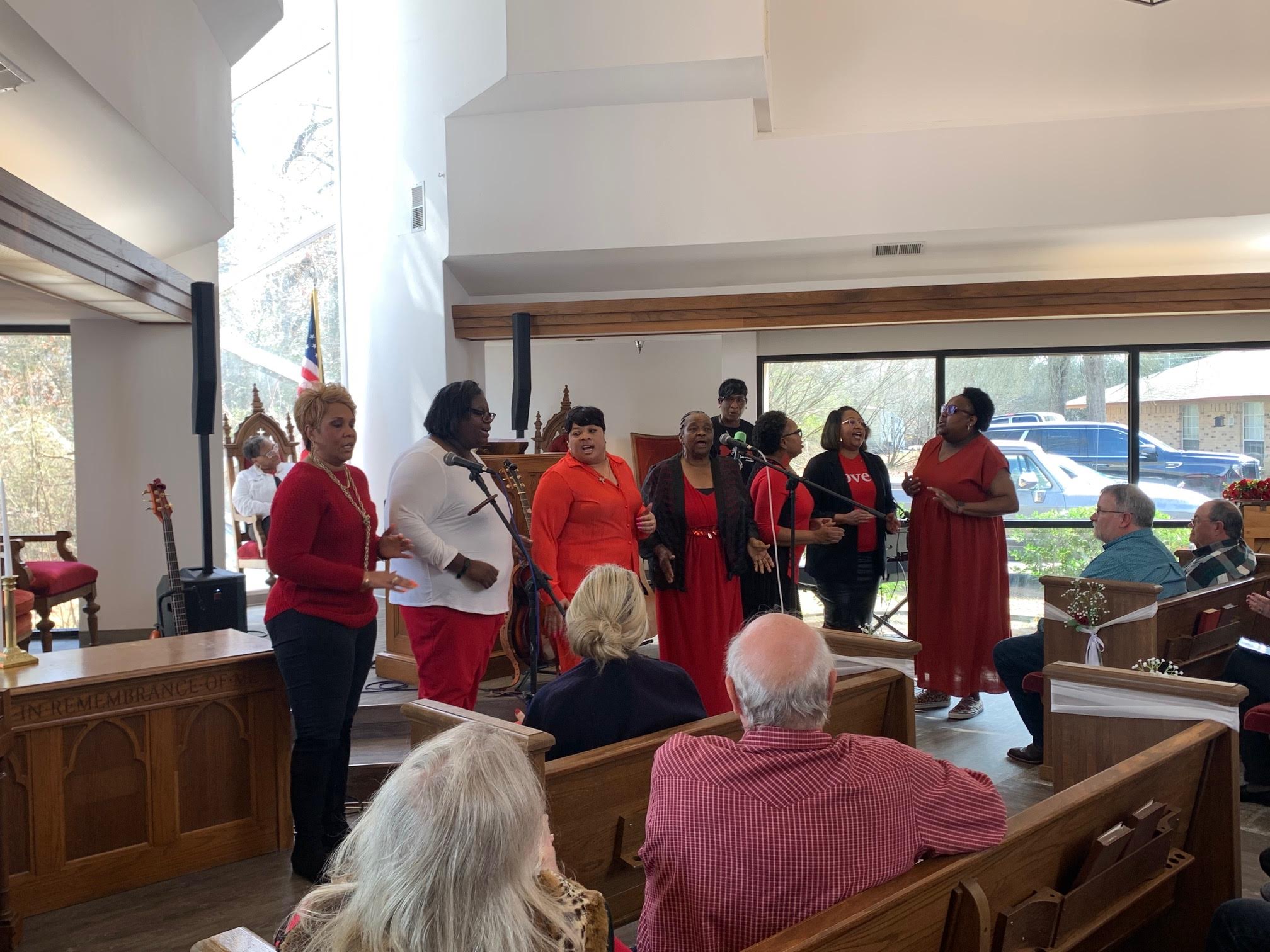 A group of people in red shirts standing around.