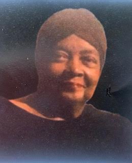 A woman wearing a hat and smiling for the camera.