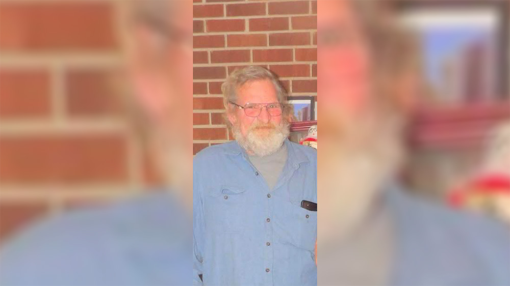 A man with long white beard and glasses.