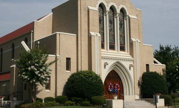 A church with two people standing in front of it.