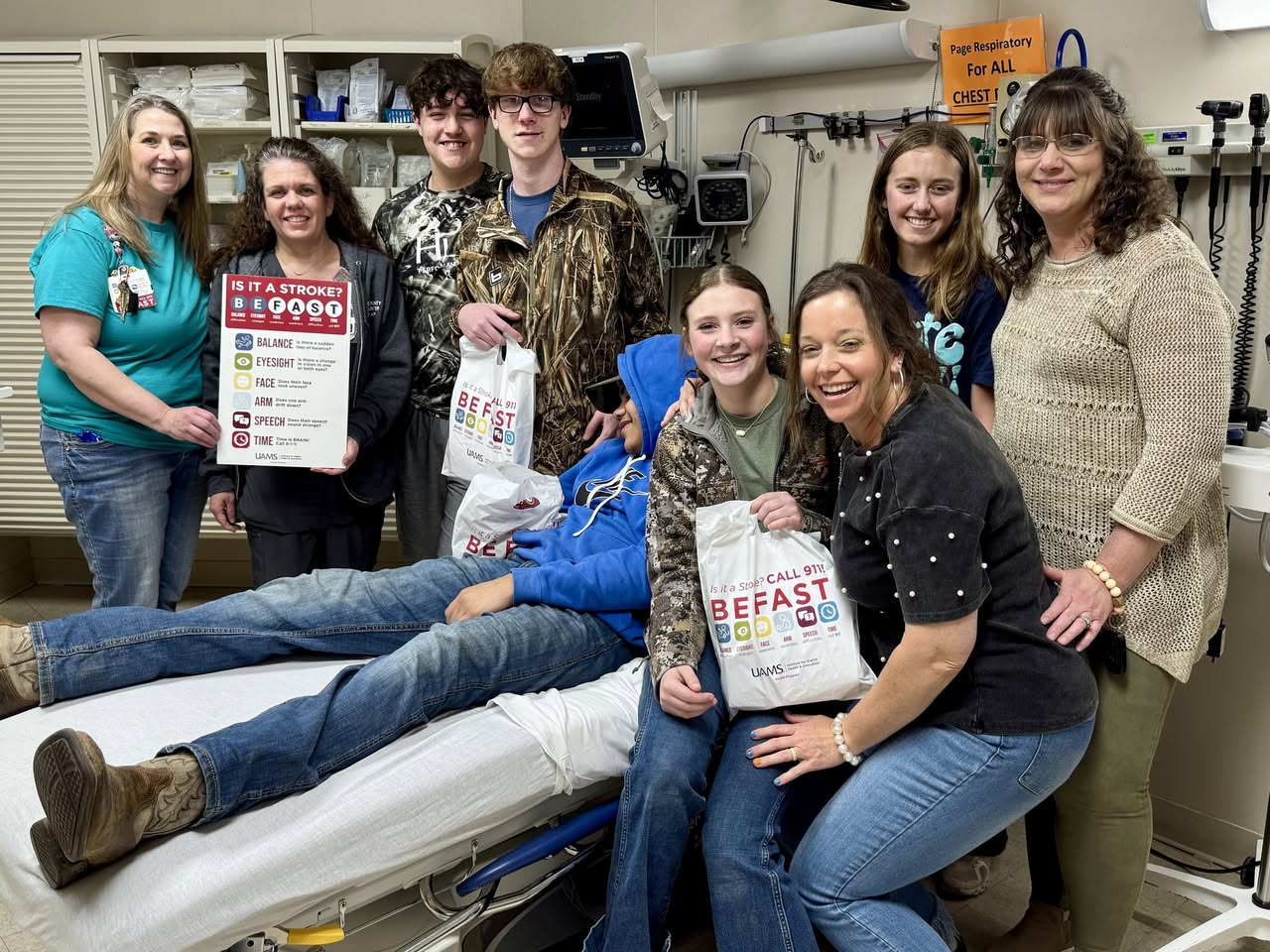 A group of people posing for the camera in a room.