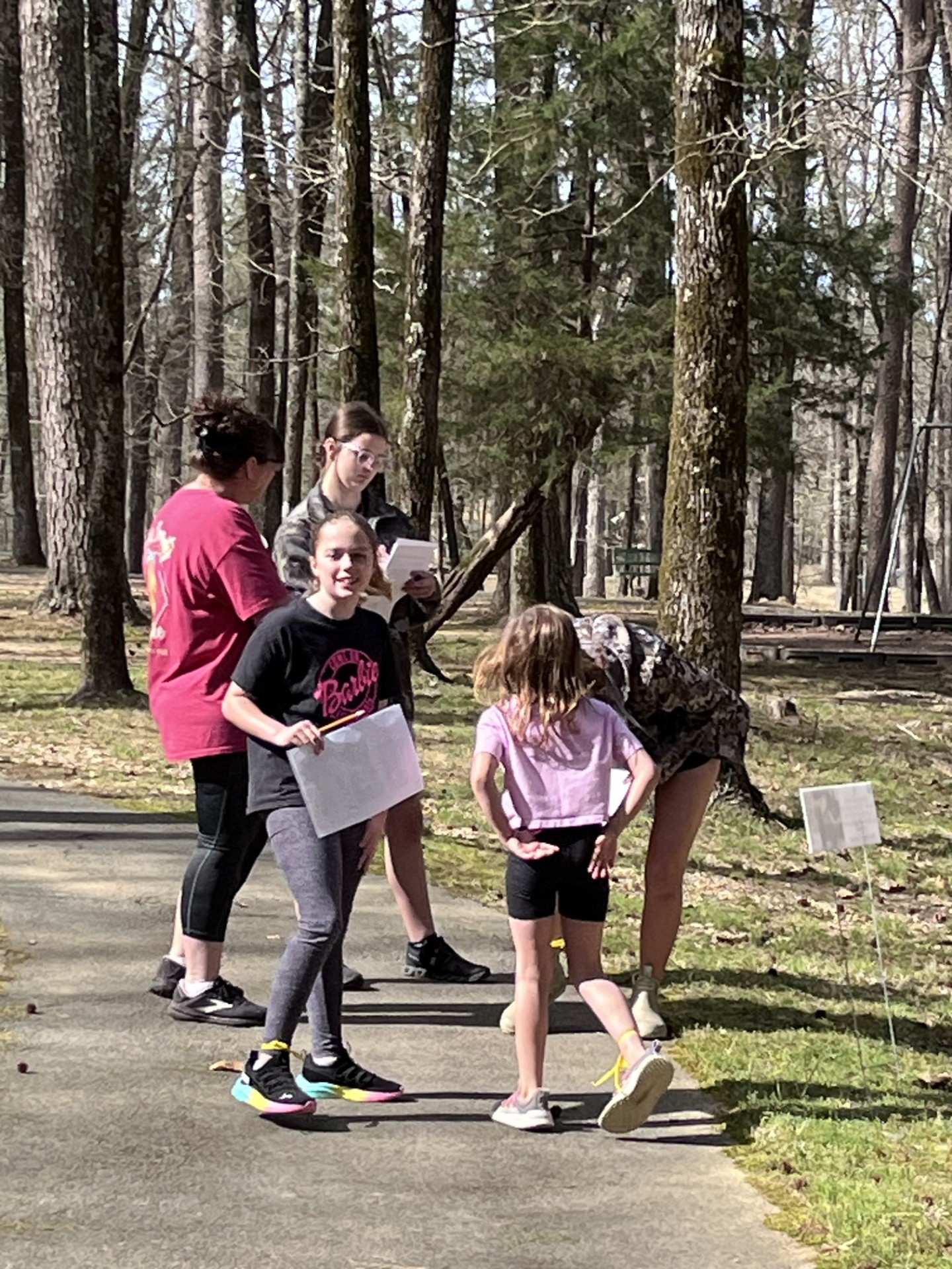 A group of people standing on the side walk
