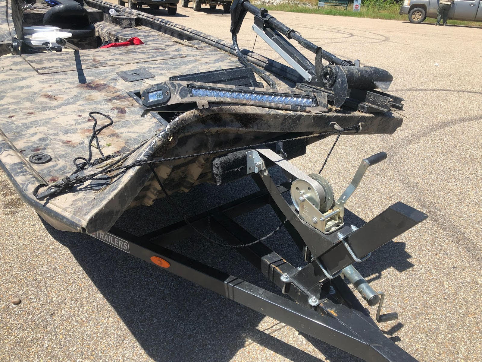 A large trailer with some parts missing on the ground