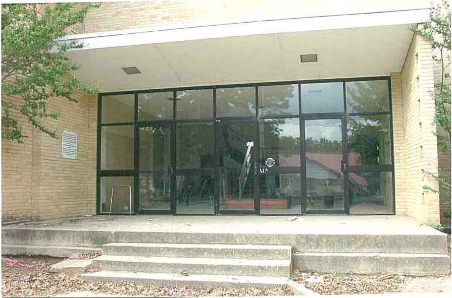 A large glass door in front of a building.