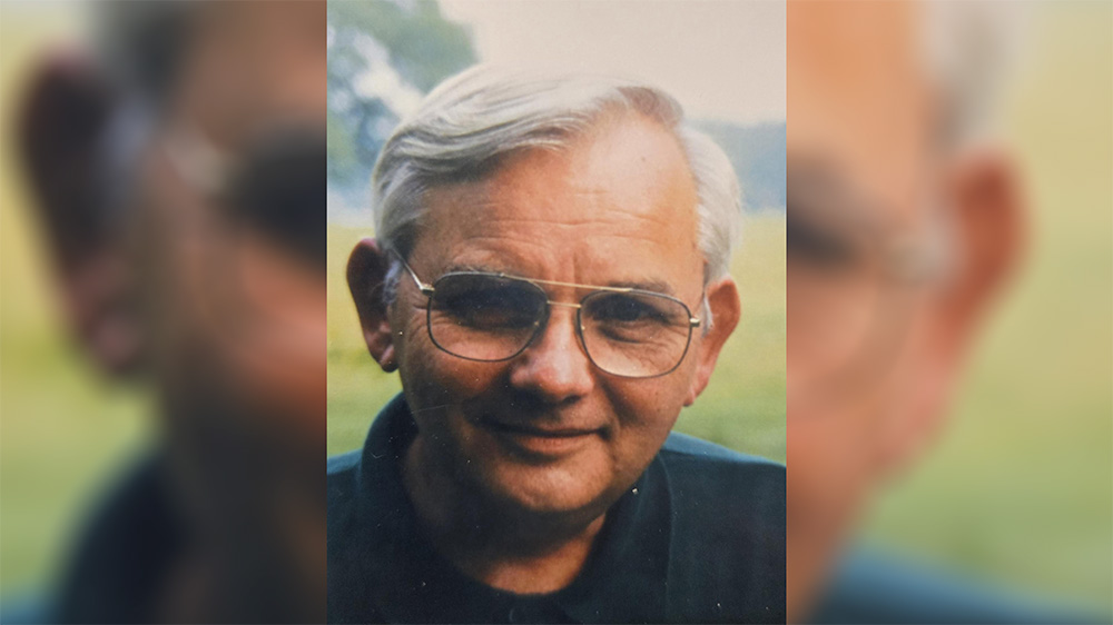 A man with glasses and white hair.
