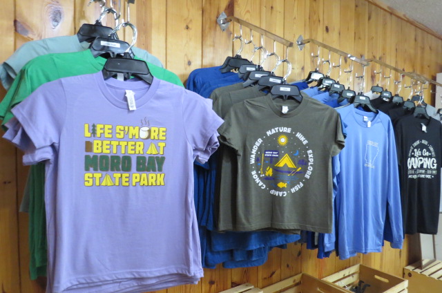 A row of shirts hanging on the wall.