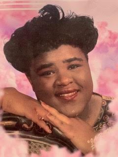 A close up of a person with a black hair style
