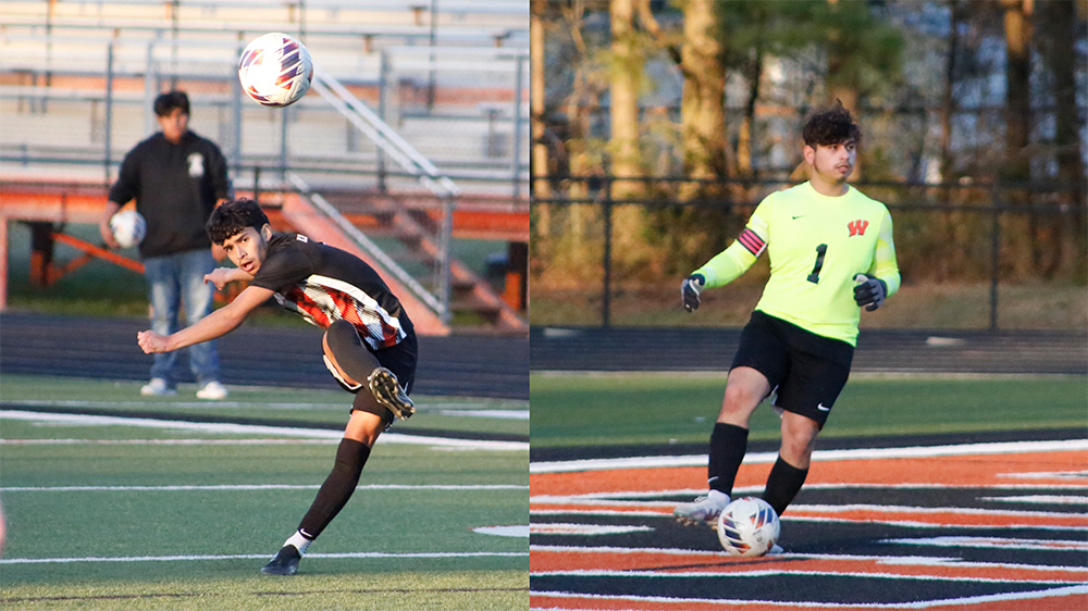 Two men playing soccer on a field.