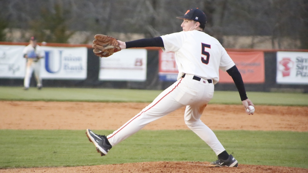 A baseball player is throwing the ball on the field.