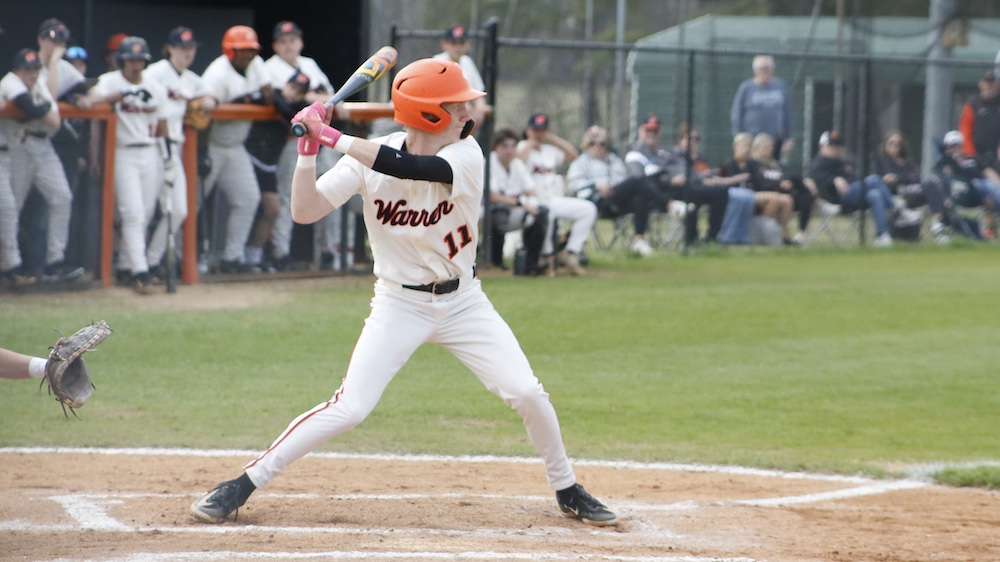 A baseball player swinging at the ball during a game.