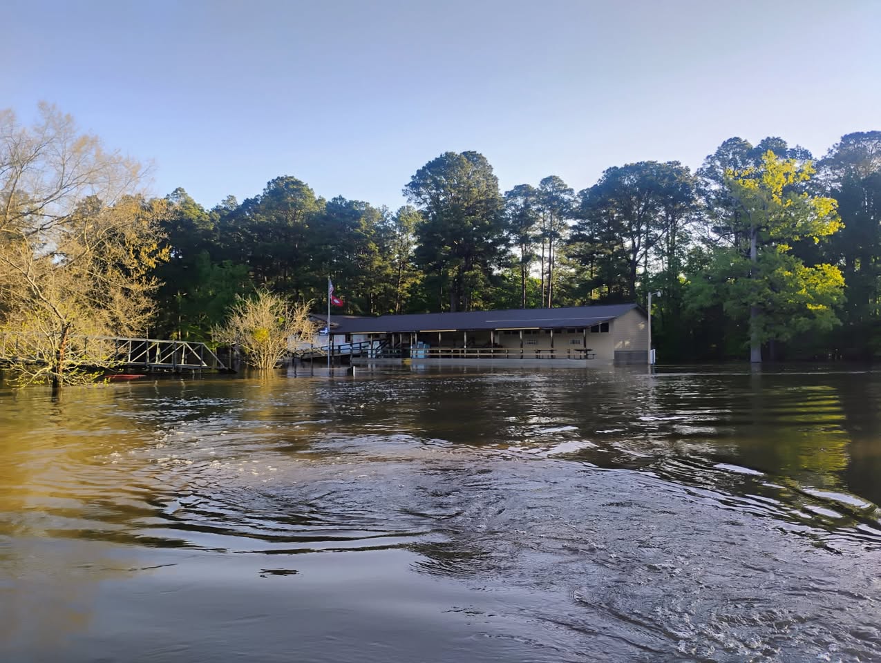 A house is surrounded by water and trees.