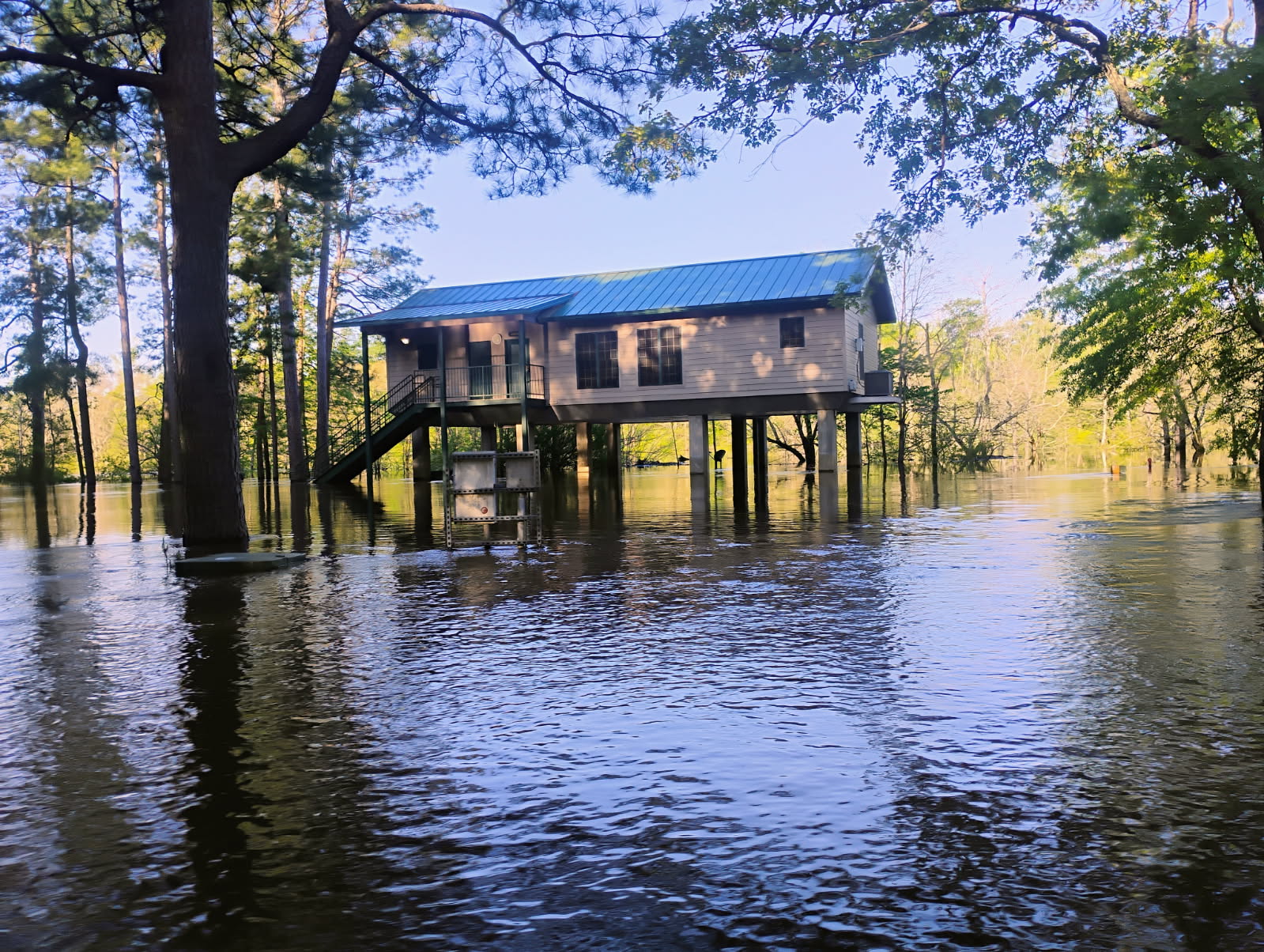 A house is shown in the middle of water.