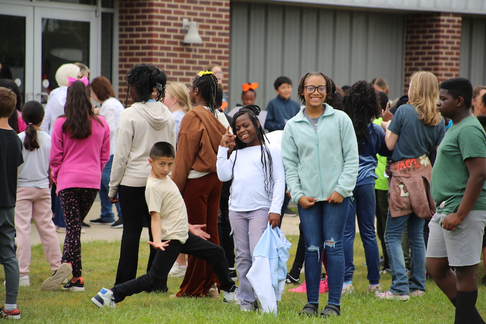 A group of people standing in the grass.