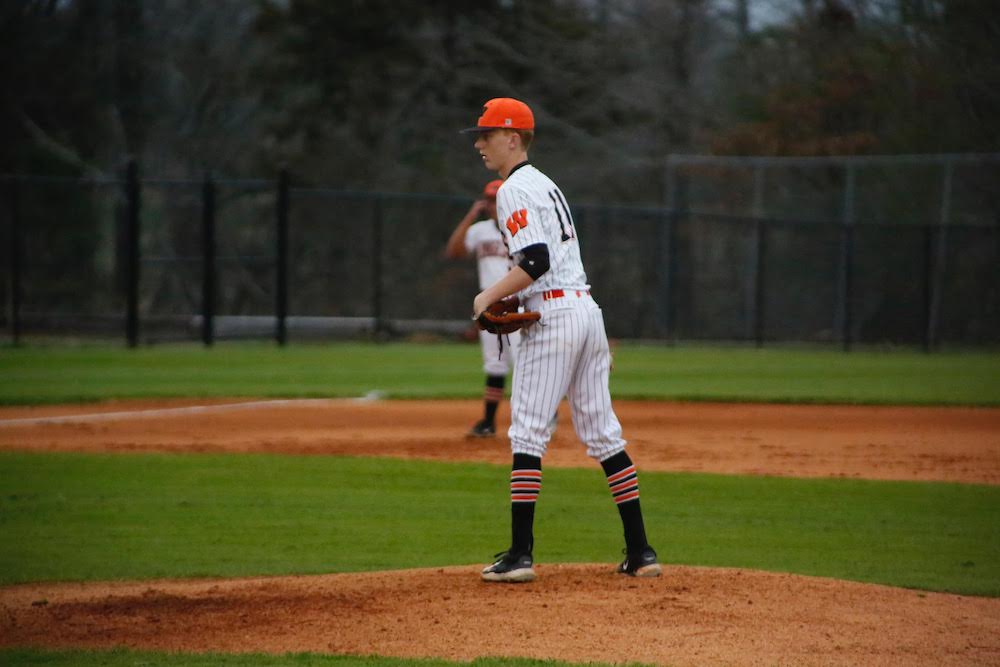 A baseball player is standing on the mound.