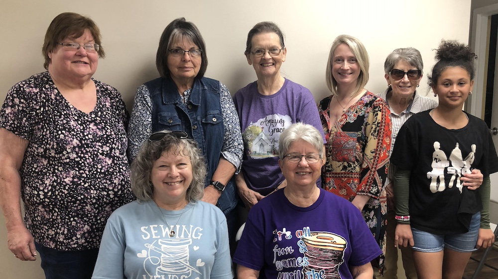 A group of women standing next to each other.