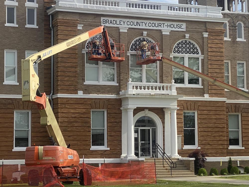 A crane is in front of the building.