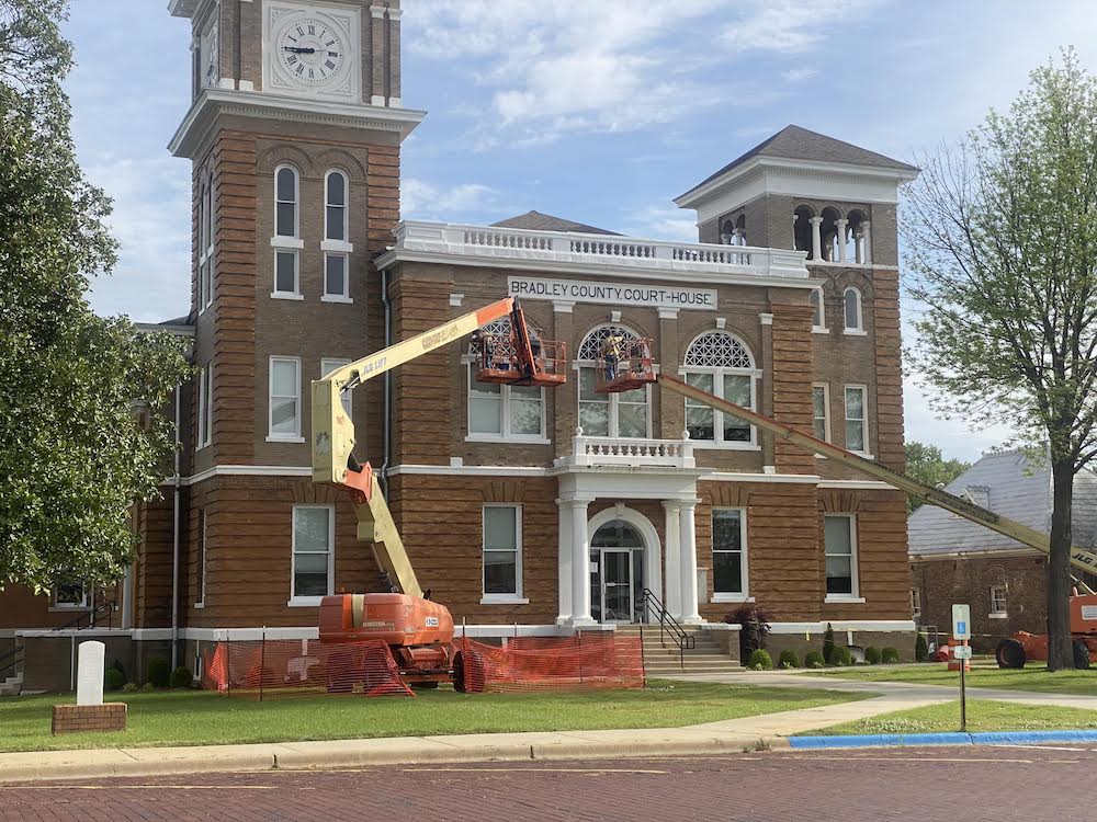 A large building with a crane on the front of it.