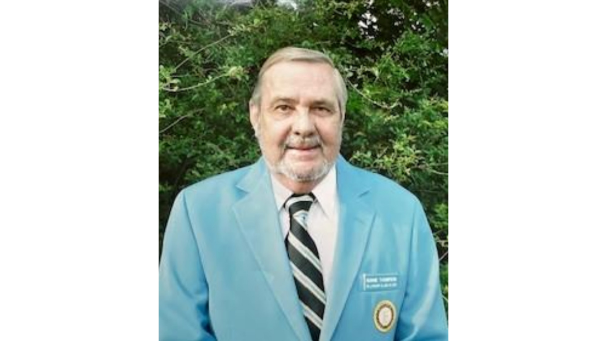 A man in a blue suit and tie.