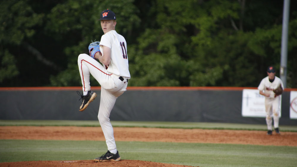 A baseball player is throwing the ball on the field.