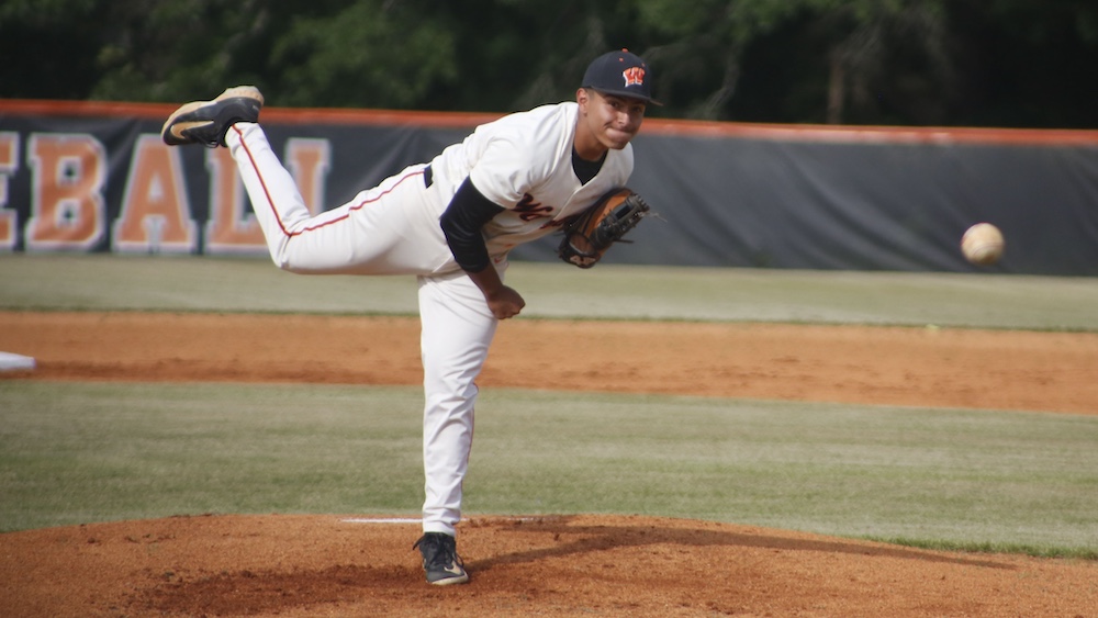 A baseball player is throwing the ball on the field.