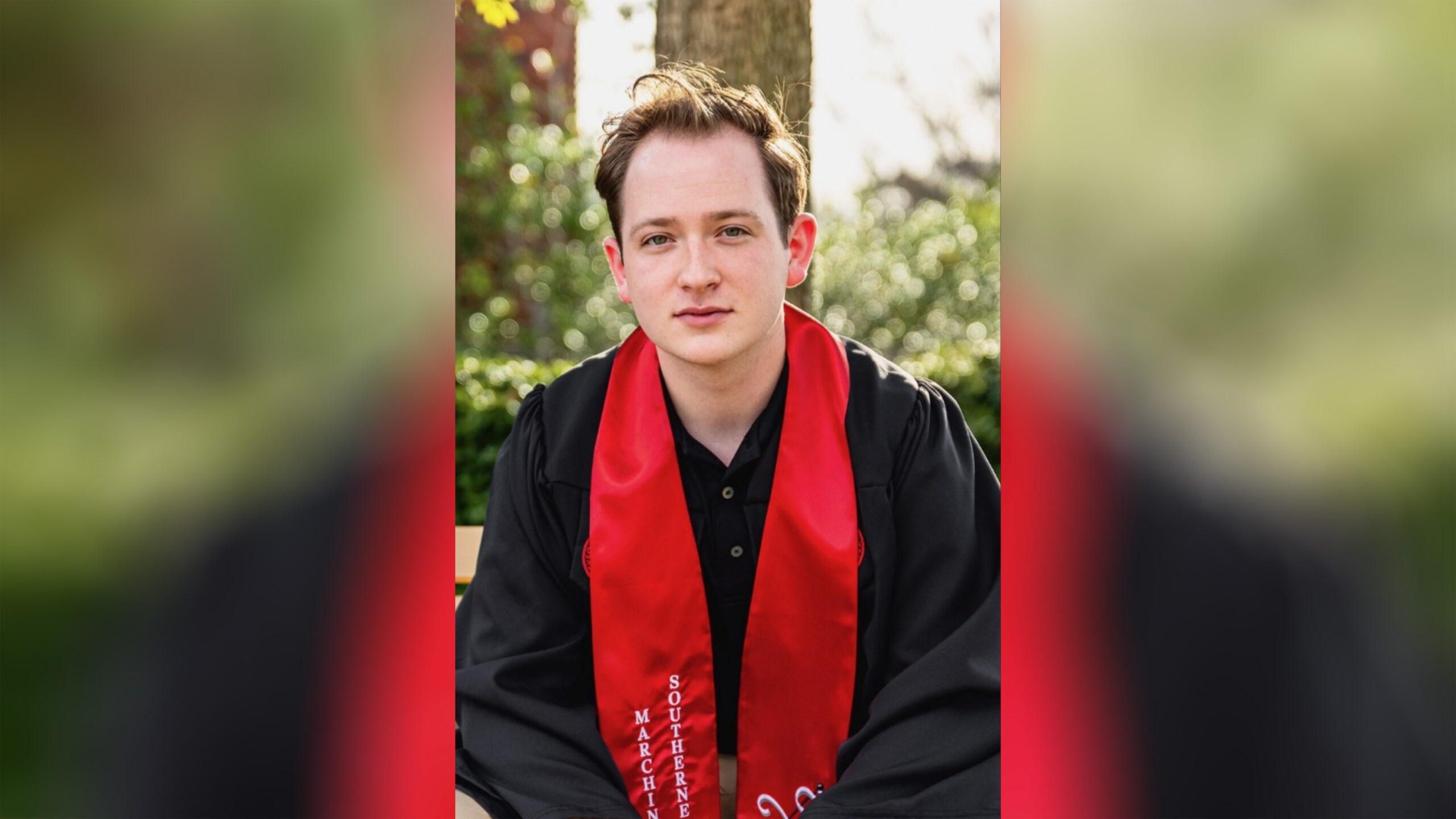 A man in black shirt and red stole.